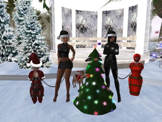 December 4th: slavin C, Diomita, slave D, Mistress Jenny and slave Flo in front of the Christmas gazebo at home